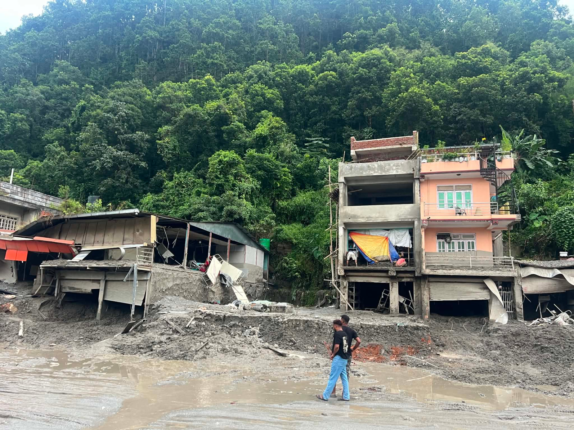 Homes and shops buried in mud and debris after the flood