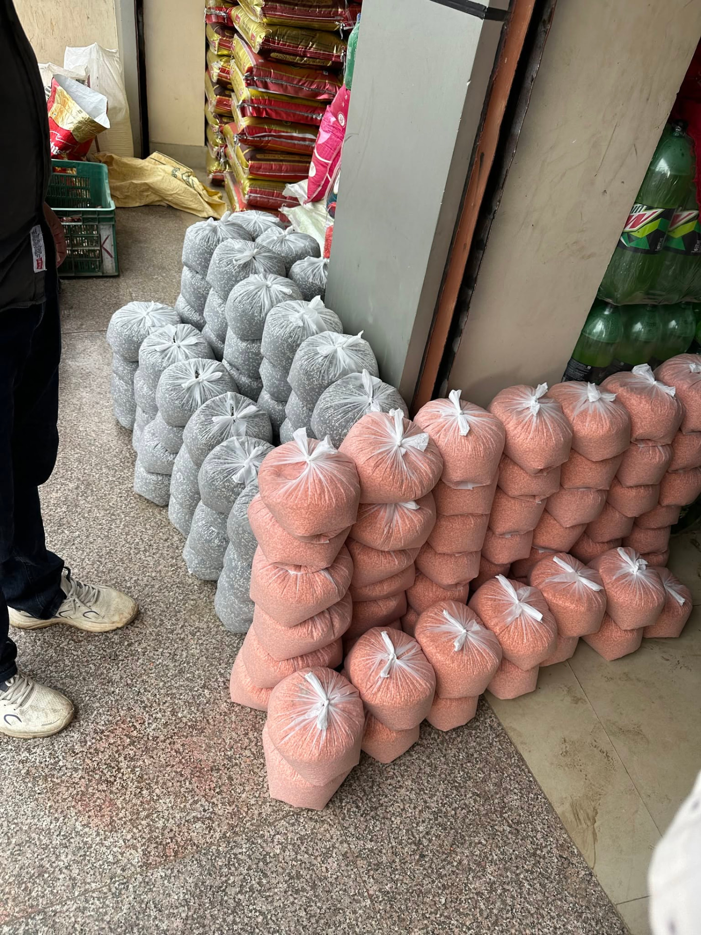 Bagged rice and lentil portions stacked ready for distribution