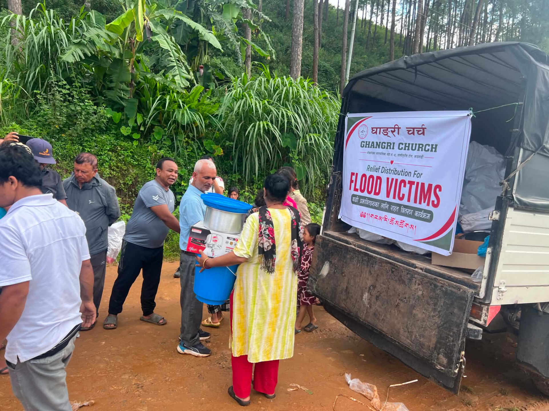A family receiving cooking materials from the relief truck