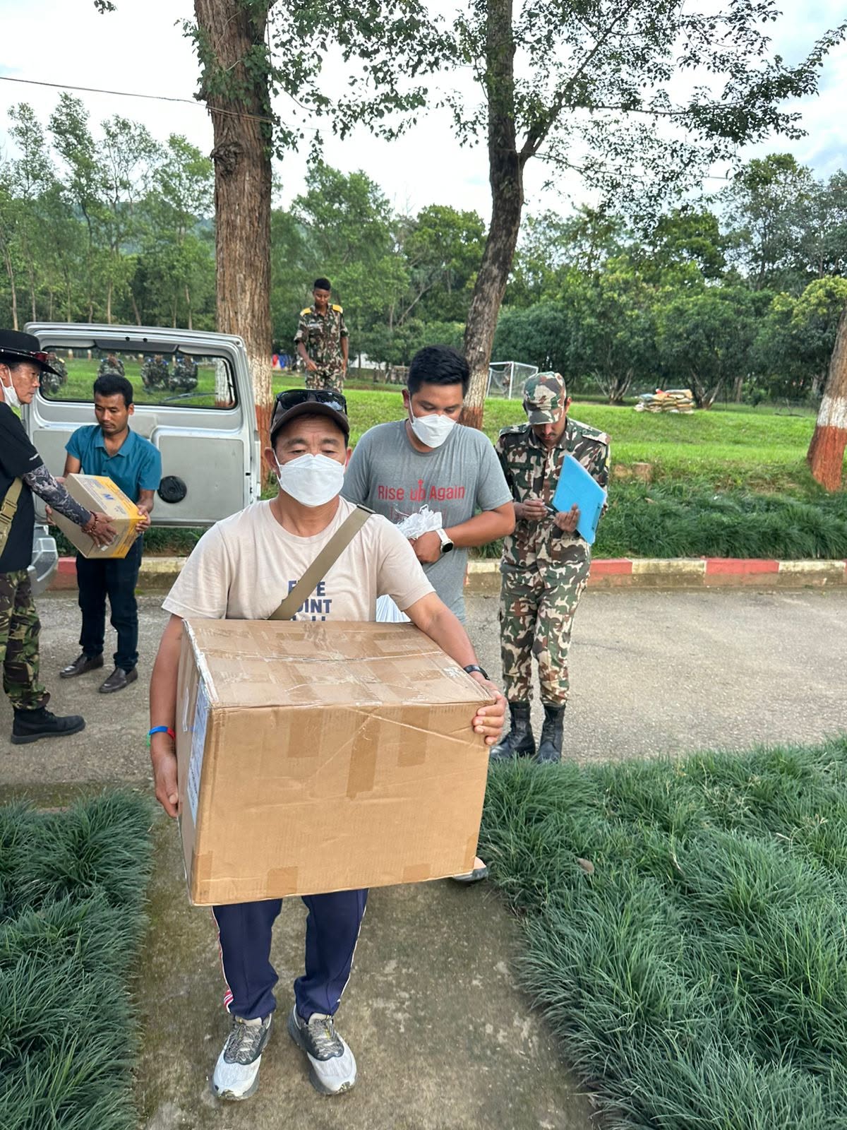 Relief boxes being carried and handed over with the Nepal Army