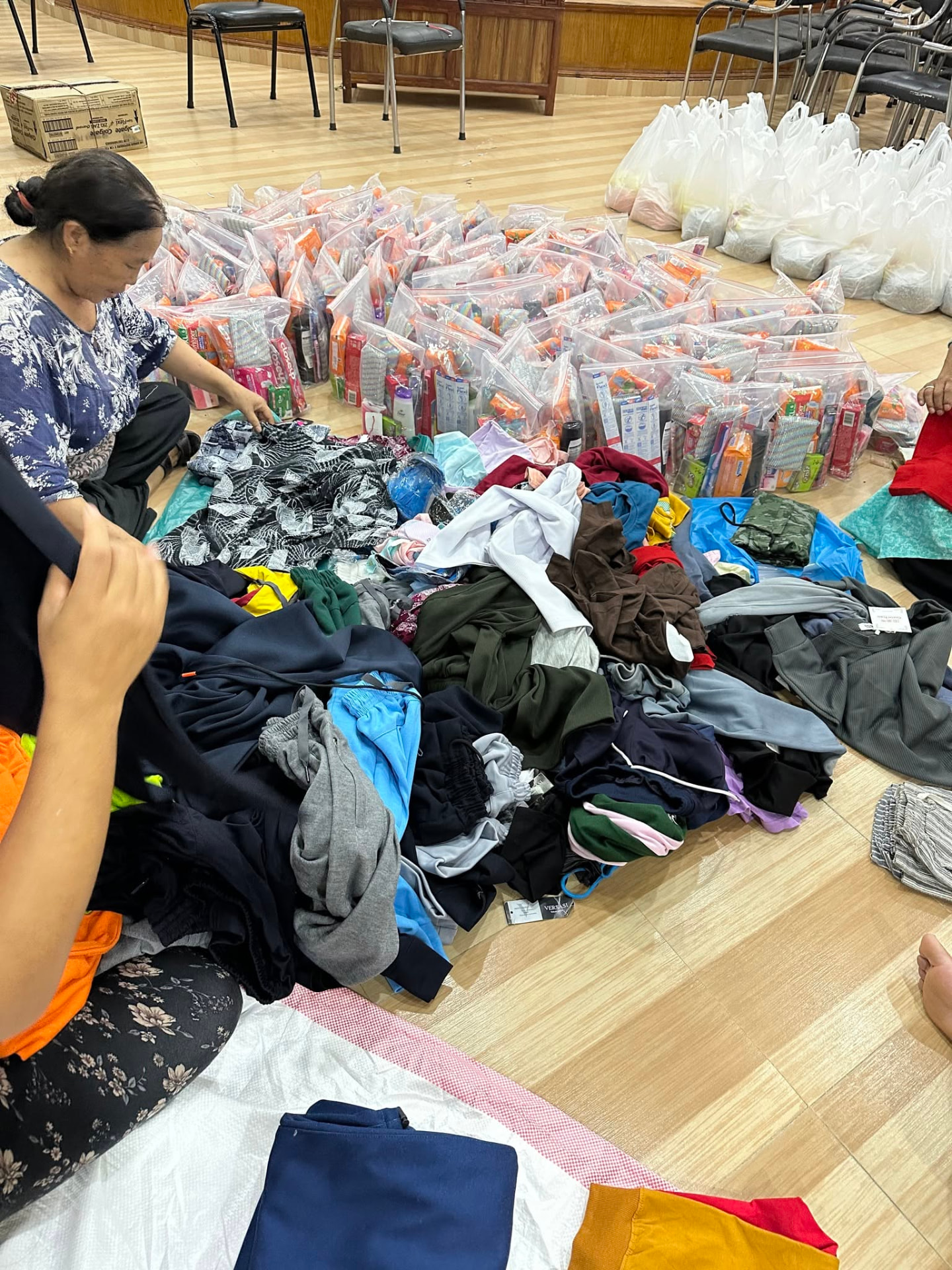 Volunteers sorting clothing and packing hygiene kits
